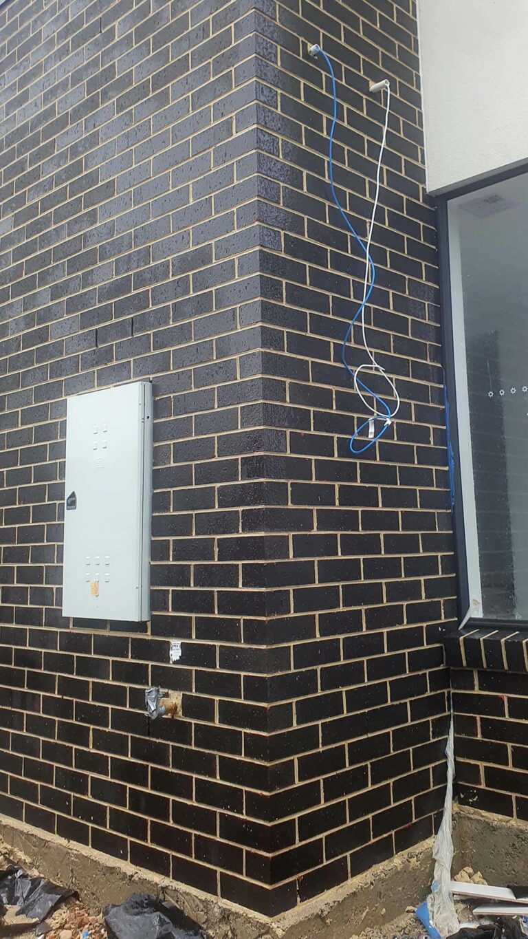 New home construction showing dark brickwork with excess mortar removed by performing Brick Cleaning services.