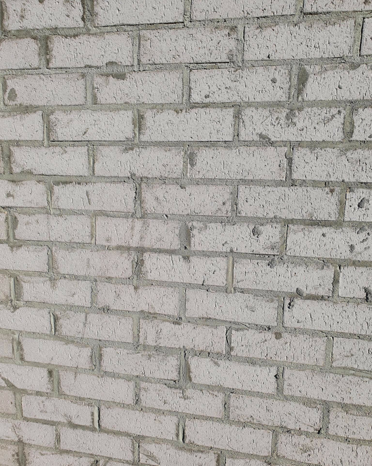 Brick wall covered in excess mortar.